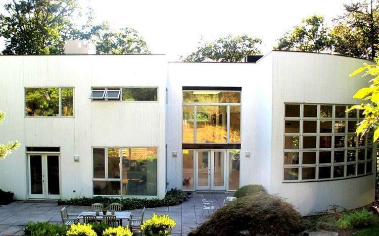 A large white house with a patio in front of it