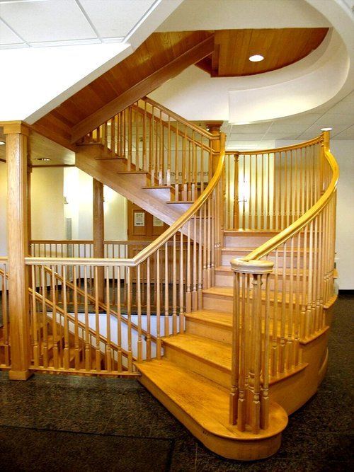 A wooden spiral staircase with a wooden railing