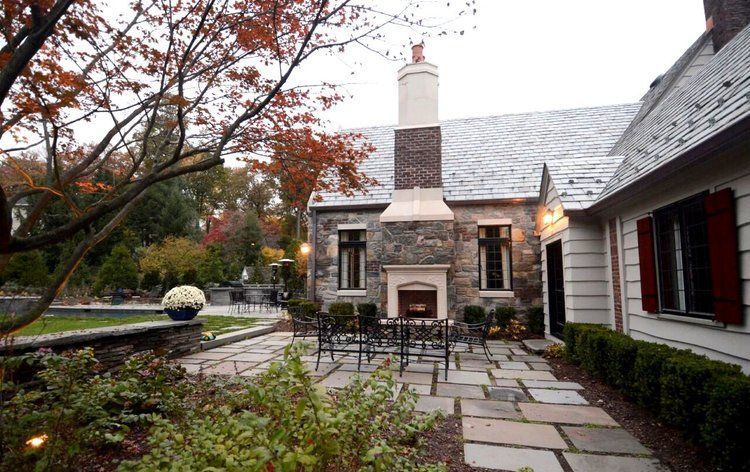 A house with a fireplace and a patio in front of it