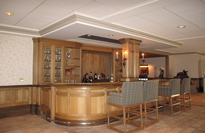 A large room with a wooden bar and chairs