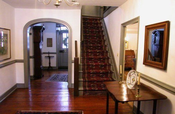 A hallway with stairs leading up to the second floor