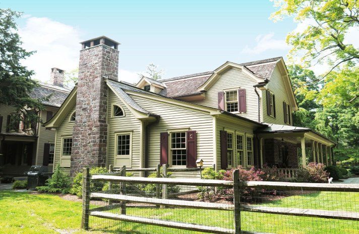 A large house with a wooden fence in front of it