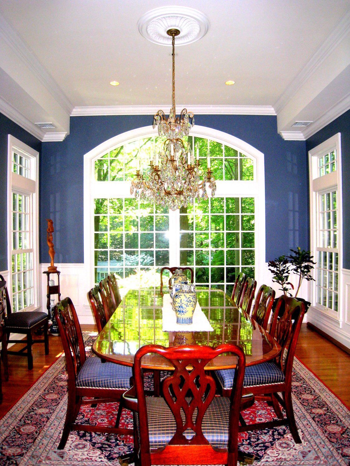 A dining room with a table and chairs and a chandelier