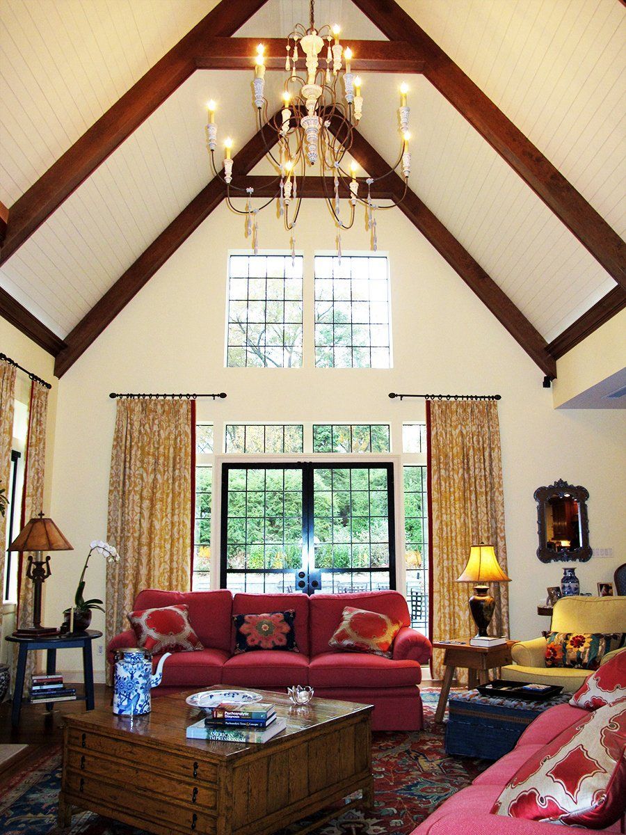 A living room with a chandelier hanging from the ceiling