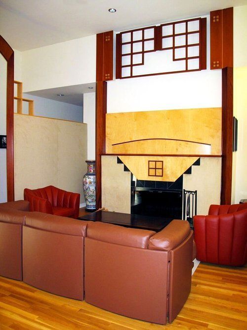 A living room with a couch and chairs and a fireplace