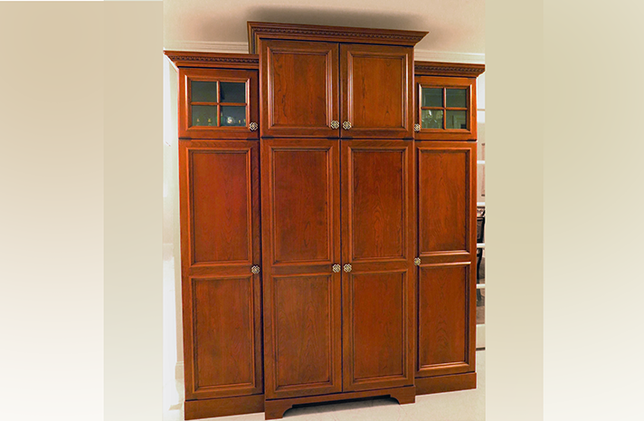 A large wooden cabinet with glass doors and drawers