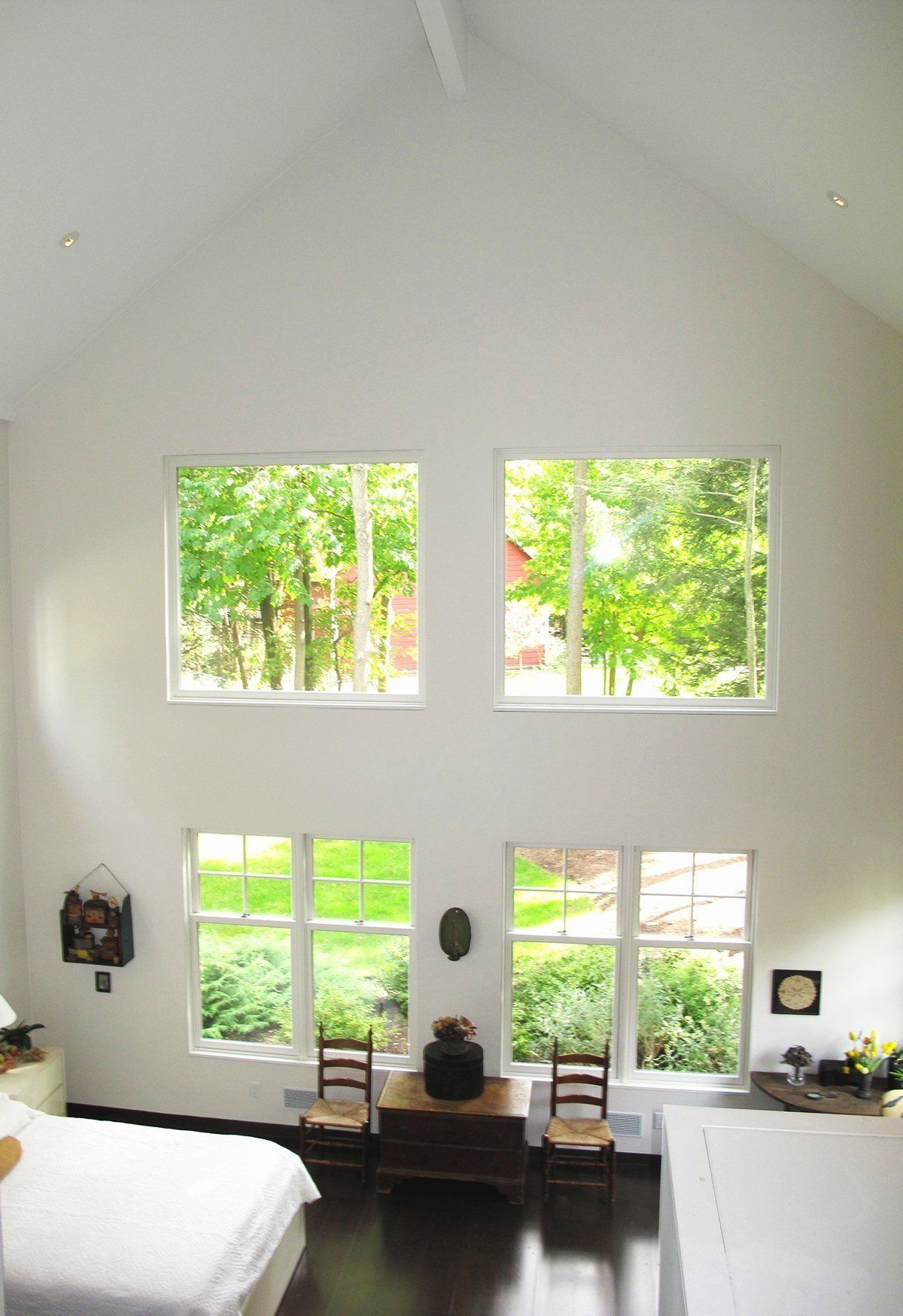 A bedroom with a lot of windows and a bed.