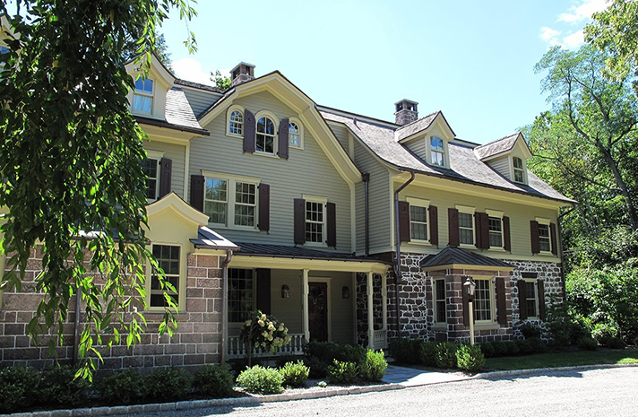 A large house with a lot of windows and shutters