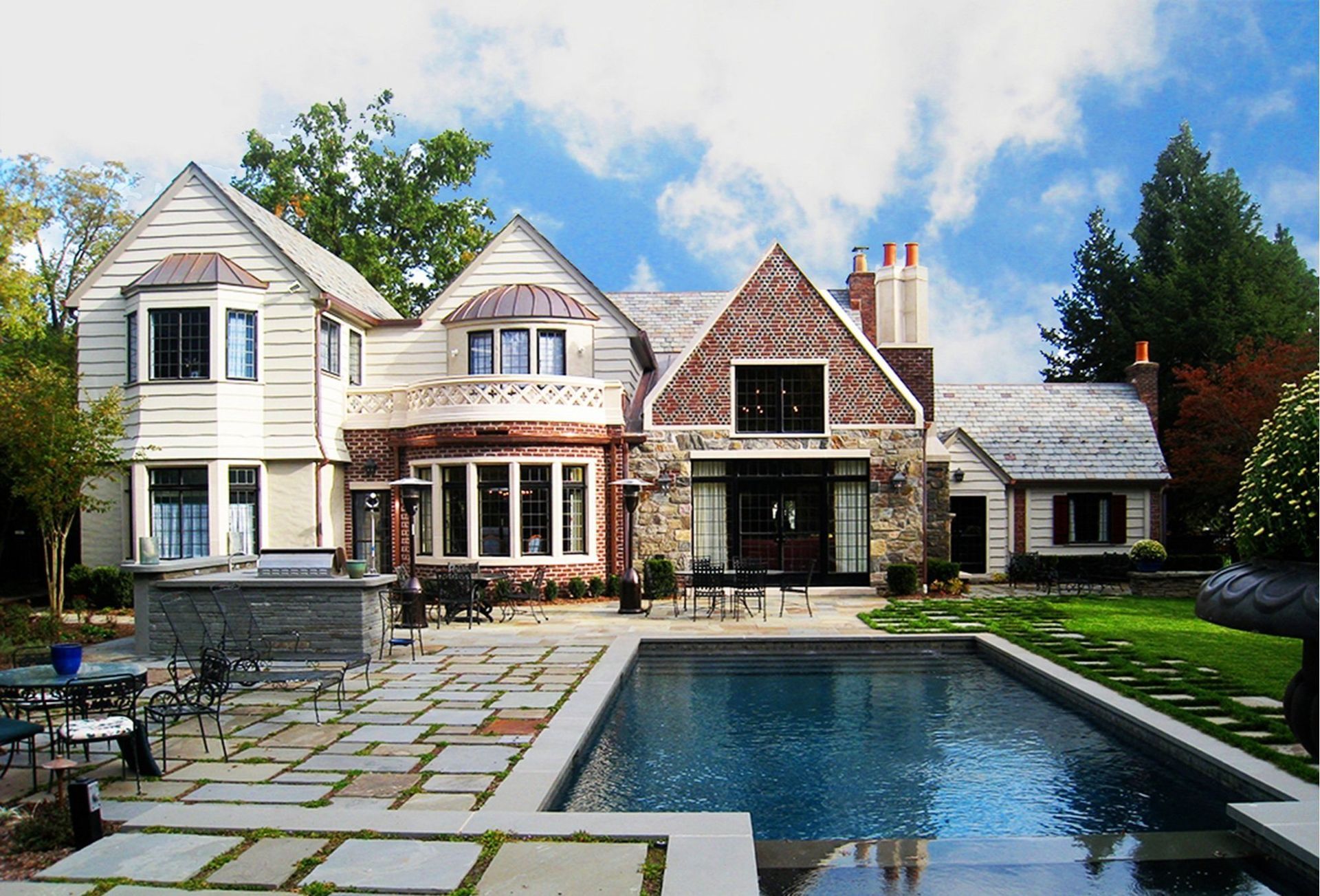 A large house with a large swimming pool in front of it