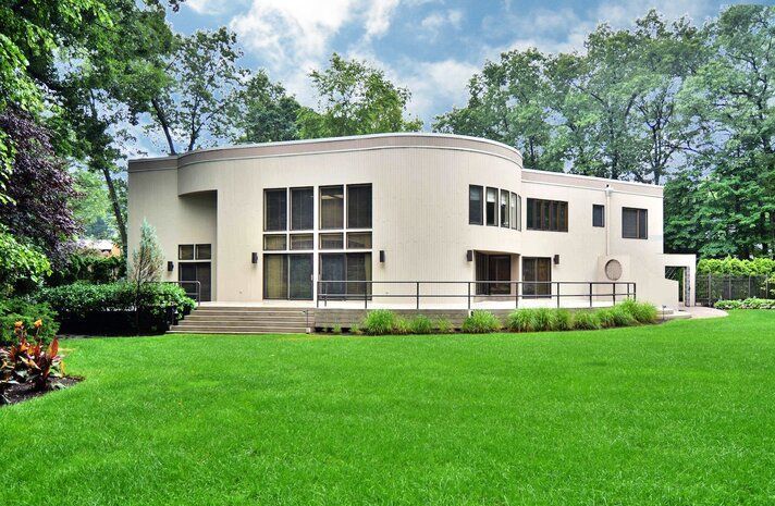 A large house with a lush green lawn in front of it