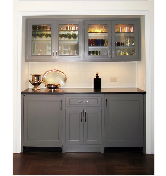 A kitchen with gray cabinets and glass doors