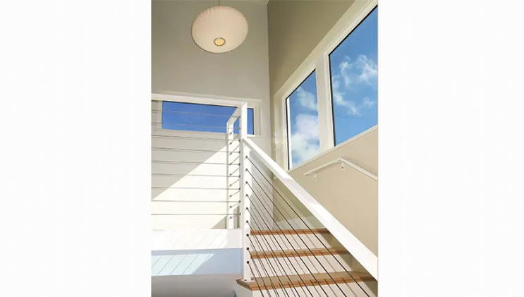 A white staircase with wooden steps and a white railing