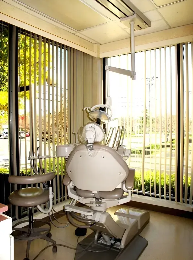 A dental office with a dental chair and a window