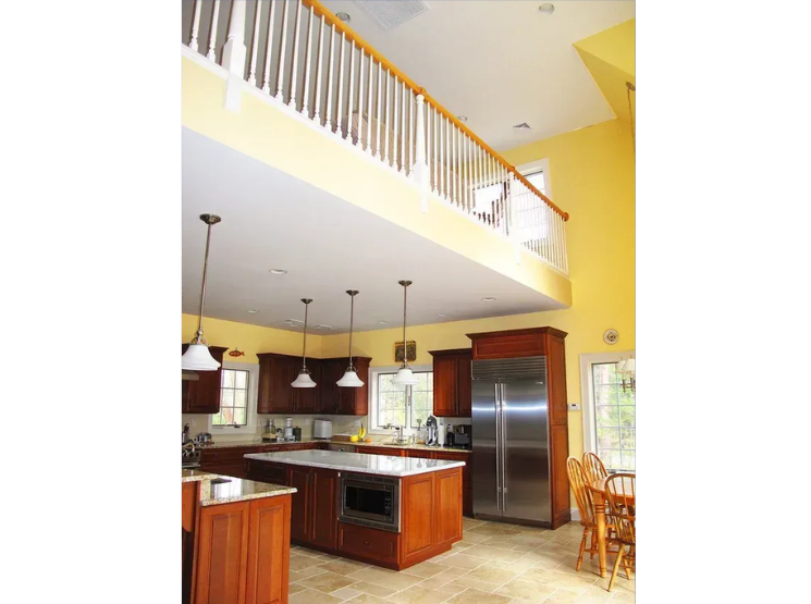 A kitchen with stainless steel appliances and wooden cabinets