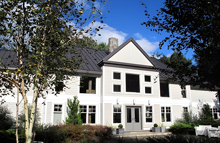 A large white house with a black roof