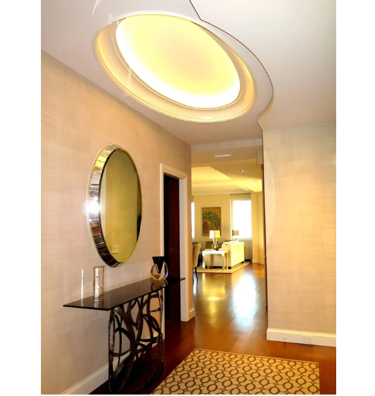 A hallway with a round mirror on the wall