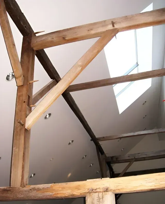 A wooden structure with a window in the ceiling