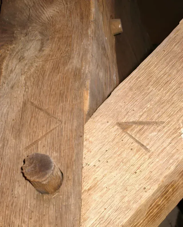 A close up of a piece of wood with a screw in it.