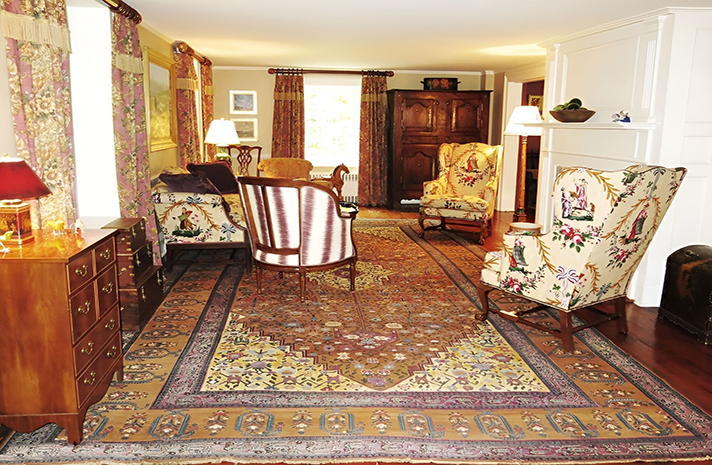 A living room filled with furniture and a rug