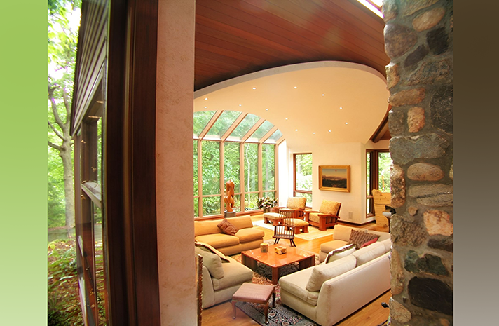 A living room with lots of furniture and a stone fireplace