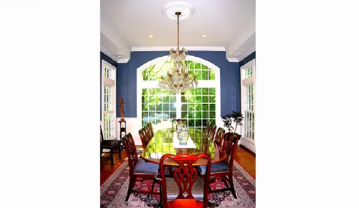 A dining room with a table and chairs and a chandelier