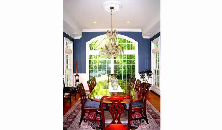 A dining room with a table and chairs and a chandelier