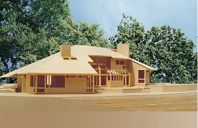 A model of a house with trees in the background