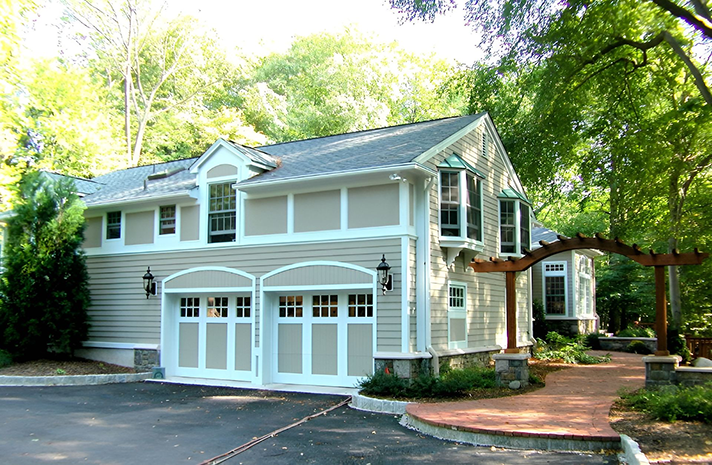 A house with a double garage and a walkway leading to it