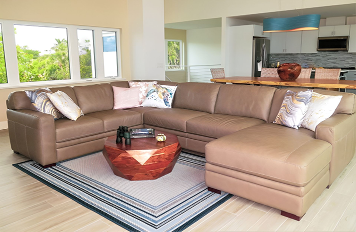 A living room with a large sectional couch and a coffee table