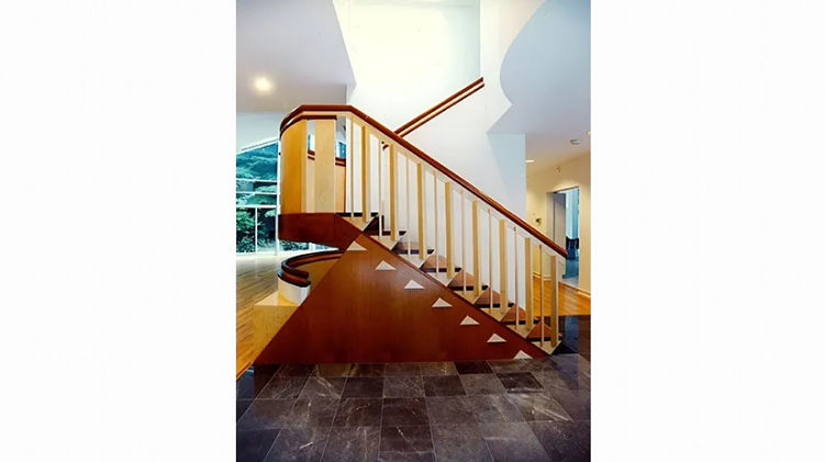 A picture of a wooden staircase in a house.