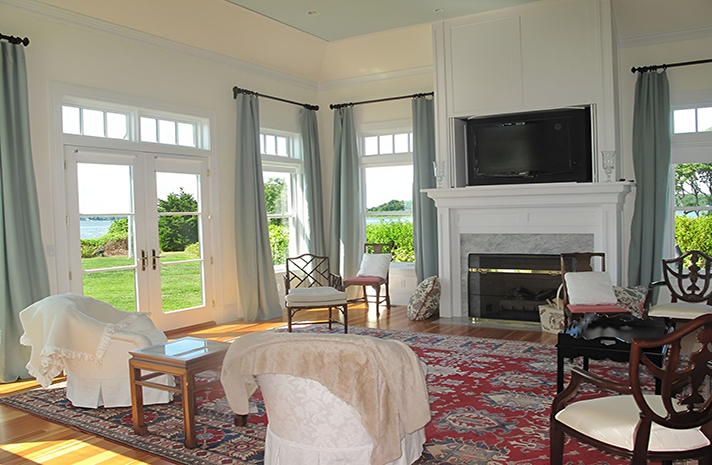 A living room with a fireplace and a flat screen tv
