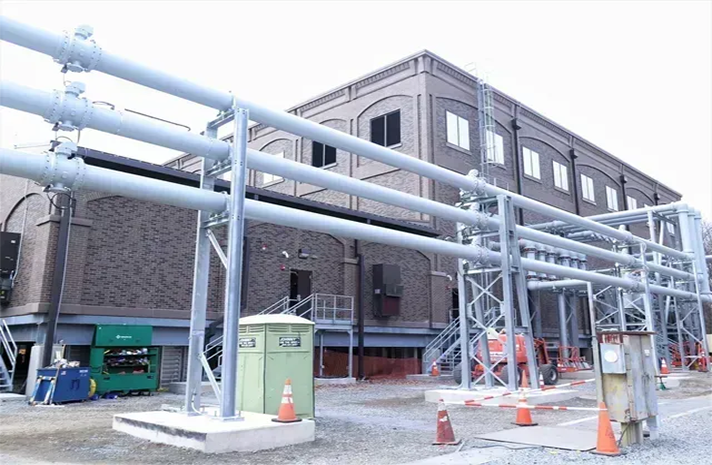 A large building with a lot of pipes going through it