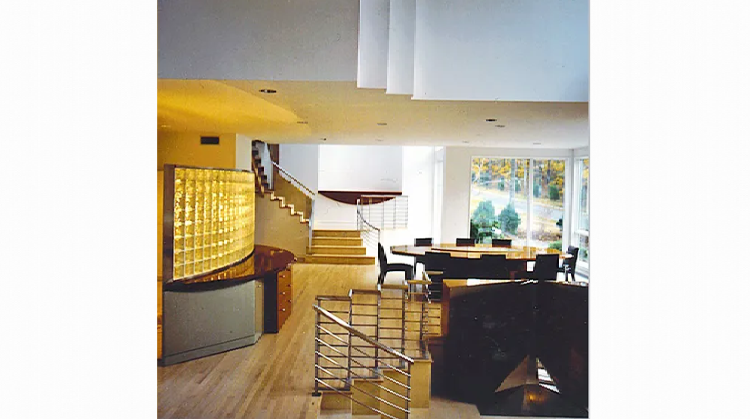 A living room with stairs leading up to the second floor