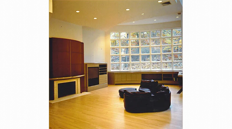 A living room with a fireplace and a large window