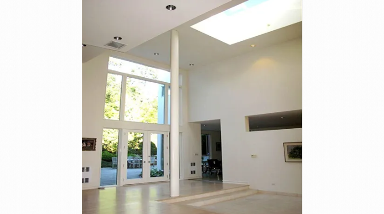 A large room with a lot of windows and a skylight