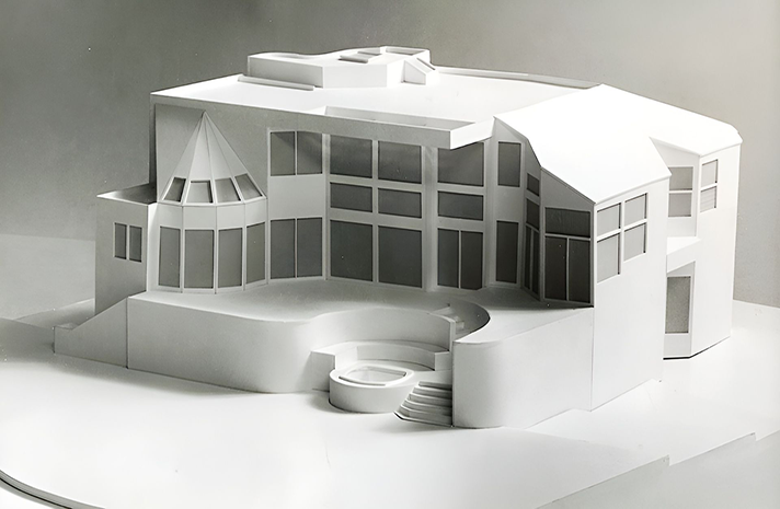 A white model of a house with a lot of windows