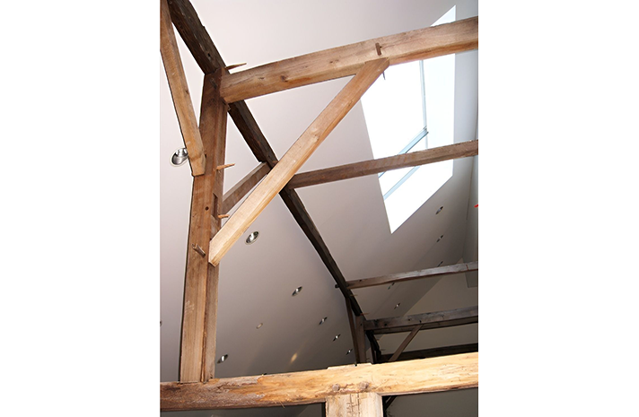 Looking up at the ceiling of a building with wooden beams