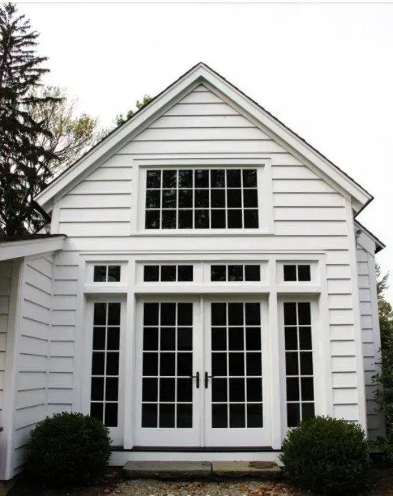 A white house with a lot of windows and doors