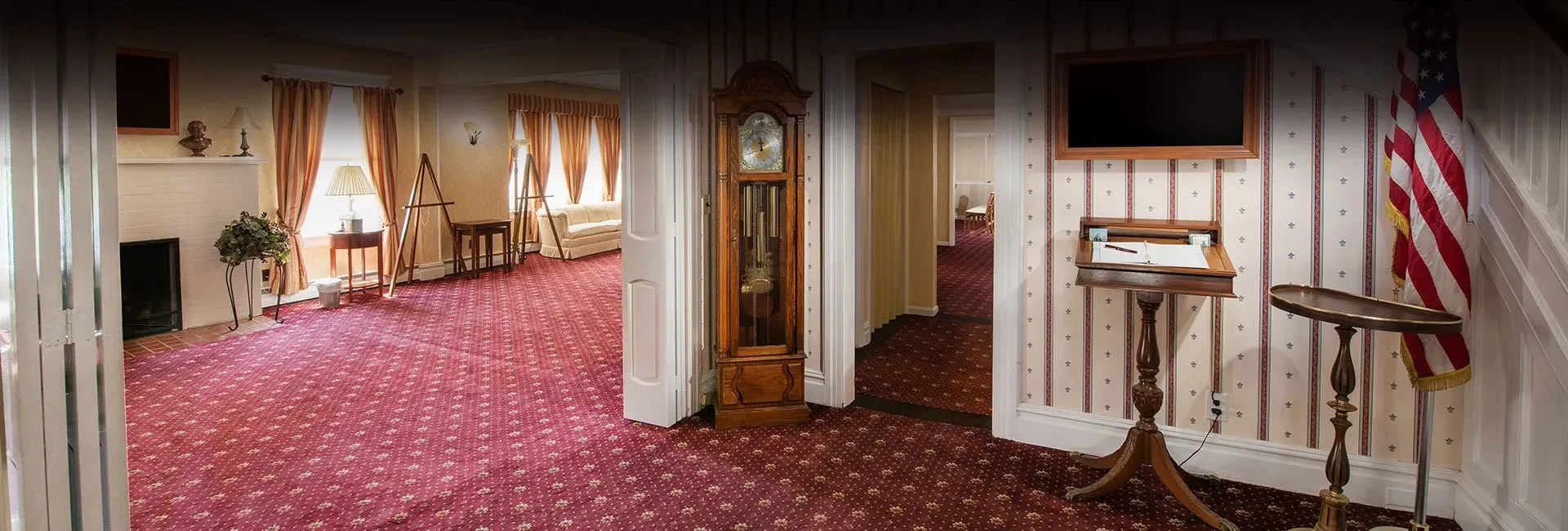 Entrance with clock and display screen and chairs