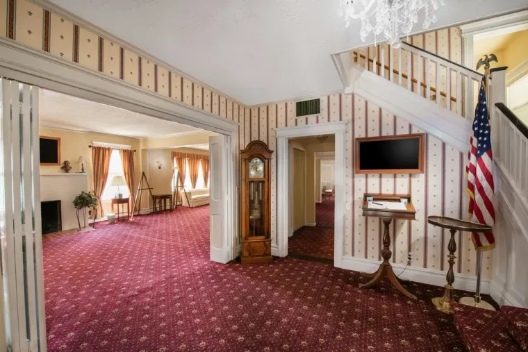 Entrance with clock and display screen and chairs