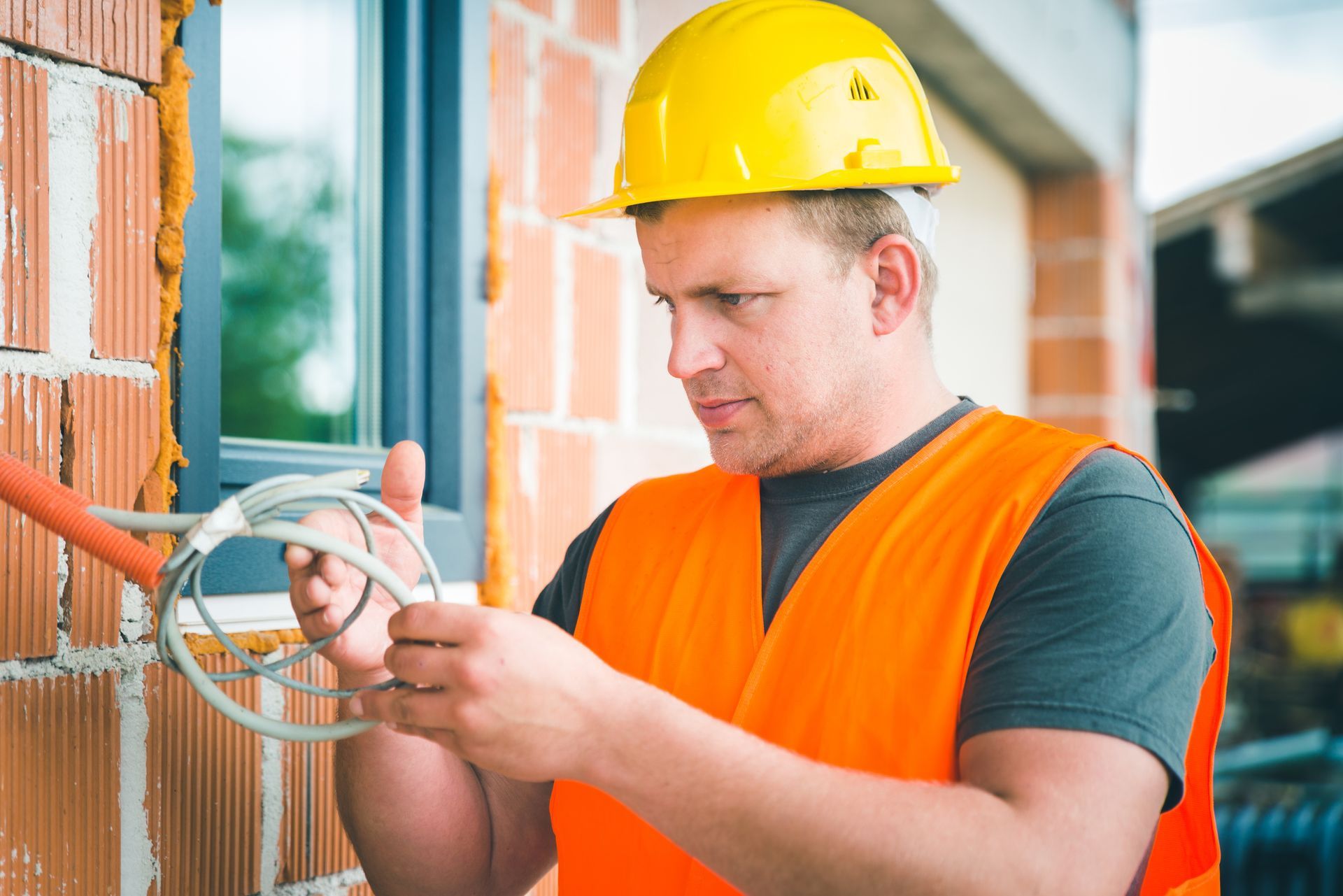 Electrician managing electrical wiring, highlighting the role of a local electrical contractor. Electrician managing electrical wiring, highlighting the role of a local electrical contractor.