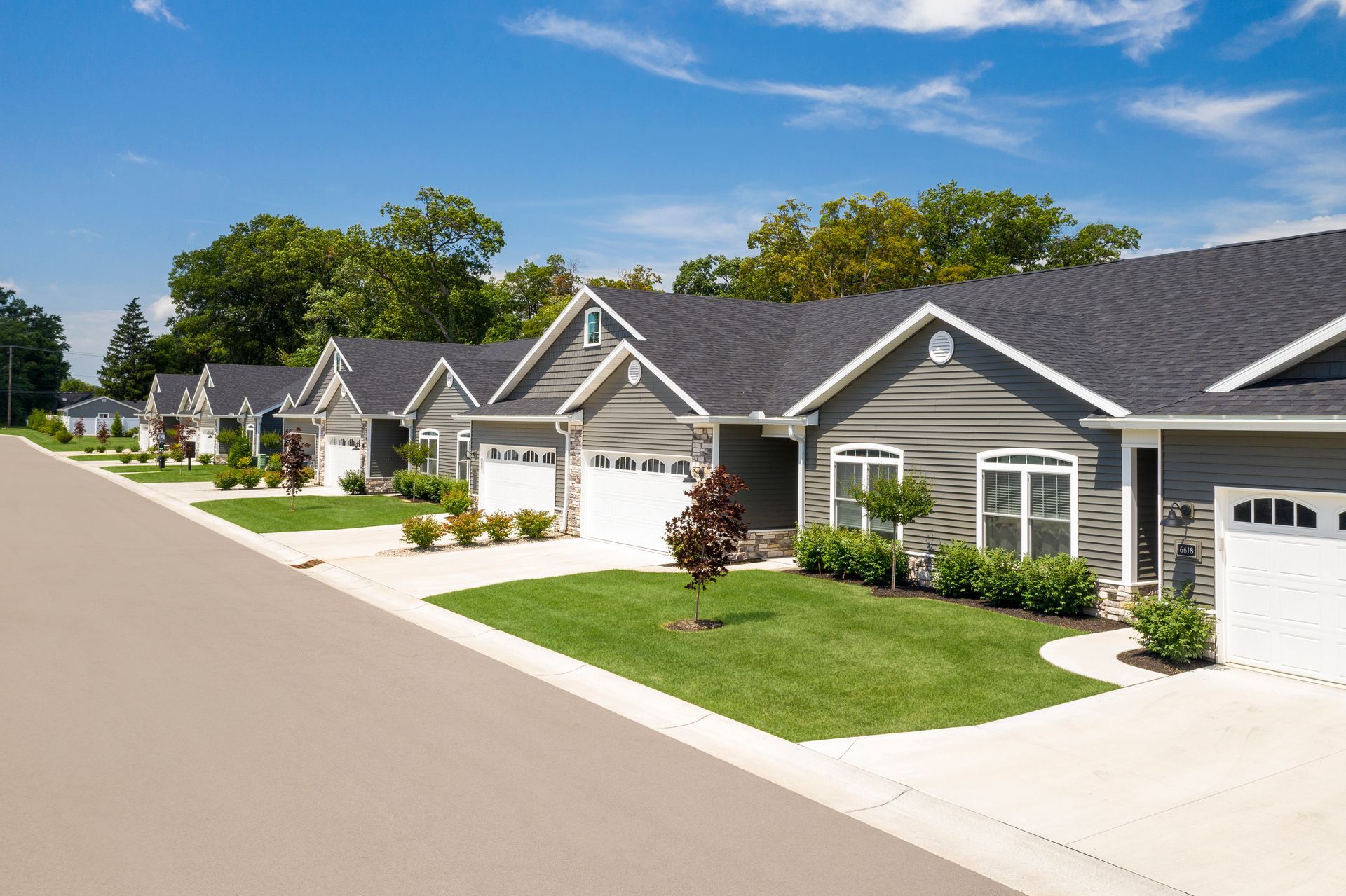 Photo of a row of duplexes with a sidewalk out front