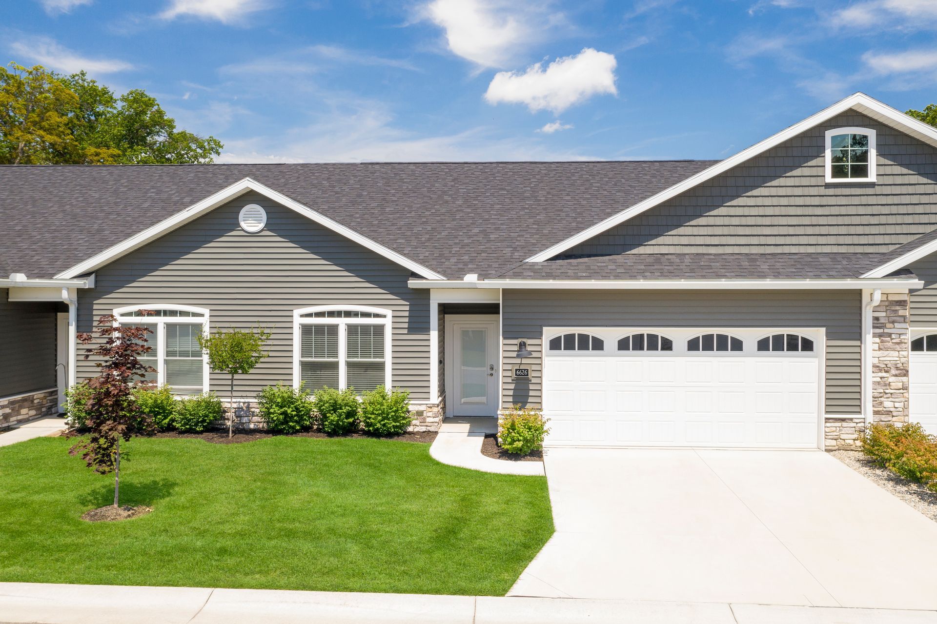 Photo of a duplex home with garages