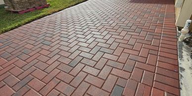 A red brick walkway with a herringbone pattern