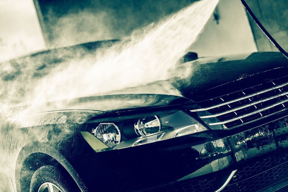 A Car Is Being Washed with A High Pressure Washer — Jetty Car Detailing Coffs Harbour in Coffs Harbour NSW