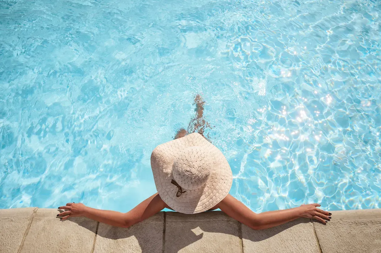Woman lounging in a pool.