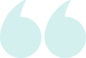 A pair of light blue quote marks on a white background.