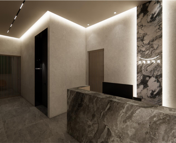 Reception area with marble desk, stone accents, and soft lighting.