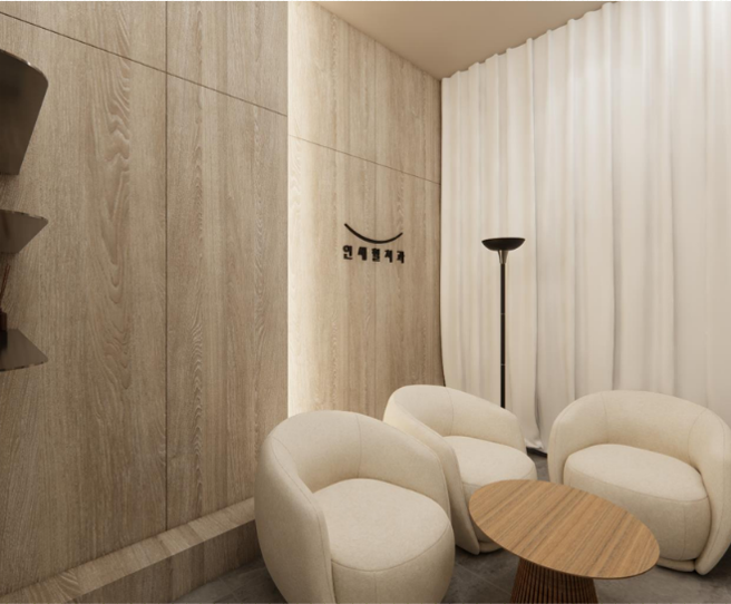 Cozy waiting area with cream-colored chairs, small round table, floor lamp, and light wood paneling and curtains.
