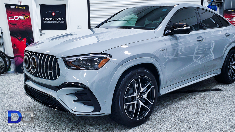 Gray Mercedes-AMG GLE Coupe with black accents, parked indoors, angled view.